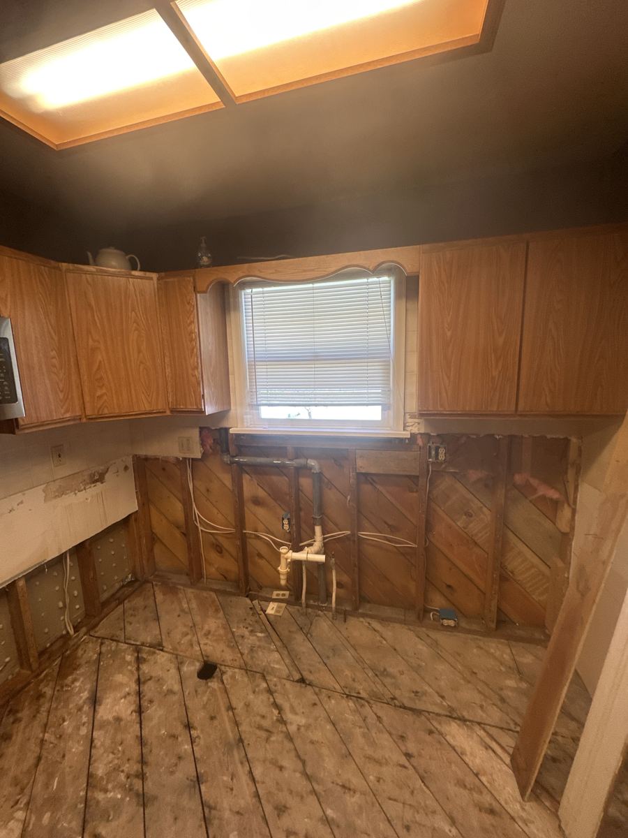 Alamosa project photo 4: Base cabinets and flooring removed down to the subfloor.