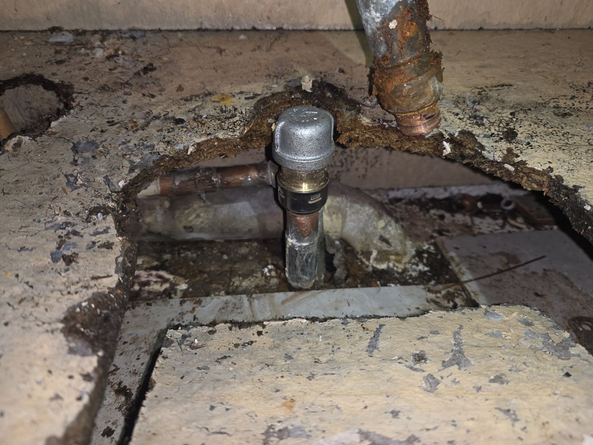Pueblo project photo 1: The leak source at the sink drain, with water damage around the pipe.