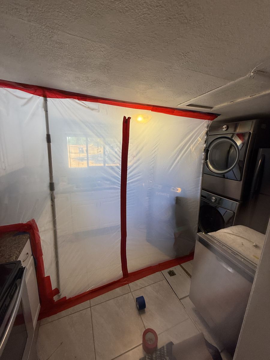 Pueblo project photo 6: Containment wall with a zipper door to keep spores out of the rest of the house.